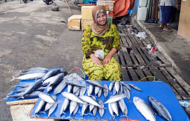 Lady selling fish in the market, Manado, Sulawesi.