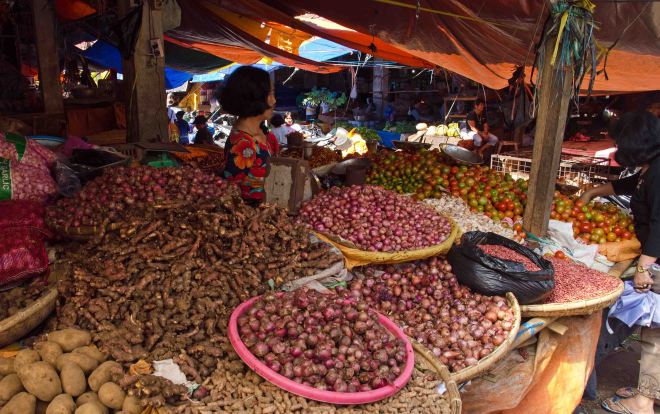 A stall selling onions, tomatoes and other vegetables in Tomohon market, Sulawesi