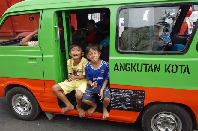 Boys on a minivan (angkut) in Bogor, Java
