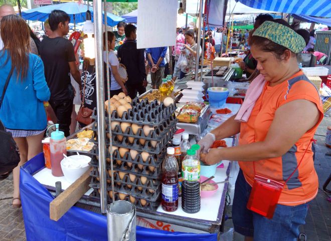Lady cooking eggs to fortify revellers